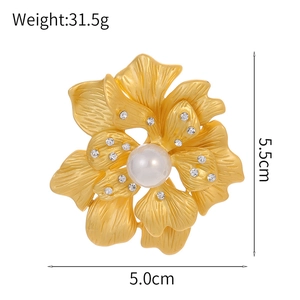 Golden peony flower pearl brooch with layered petals and crystal accents on white background