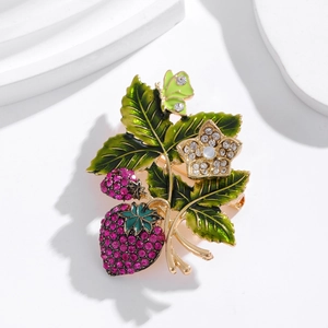Vintage gold strawberry brooch with ruby crystals and green enamel leaf design