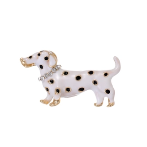 Detailed close-up of enamel puppy brooch with black spots and crystal collar decoration