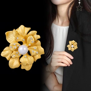 Peony flower brooch with pearl and crystal petals on elegant black blazer