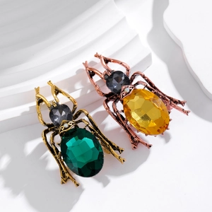 Exquisite vintage crystal beetle brooches in gold and bronze with vibrant gemstones
