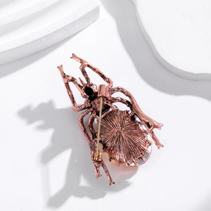 Vintage beetle brooch in bronze finish showing a detailed back view and secure pin clasp