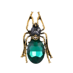 Vintage beetle brooch with emerald green gemstone and antique gold metal finish