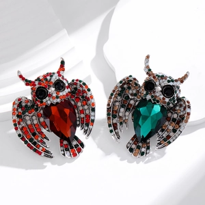 Elegant owl brooches set with crystal gemstones and rhinestones on silver-toned metal