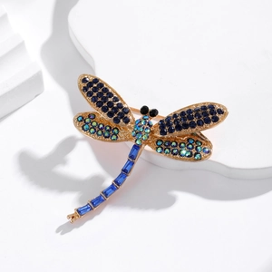 Elegant vintage dragonfly brooch with blue crystals on a golden alloy base