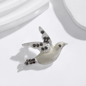 Flying bird pigeon brooch in silver alloy with white enamel and black sparkling crystals