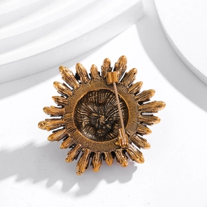 Vintage gold sunflower brooch with textured metal petals and secure pin clasp closure
