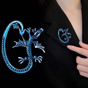 Elegant blue dragon brooch in enamel finish on black suit lapel with zircon detail