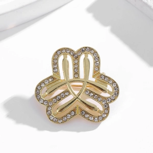 Elegant gold-tone brooch with pearl and crystal leaf design on a white background