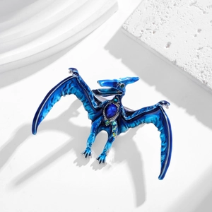 Mythical blue enamel dragon brooch with crystal wing details on white background