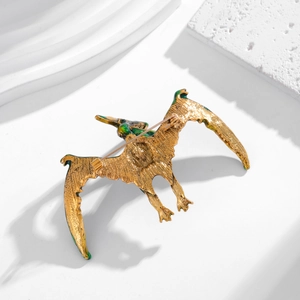 Detailed back view of golden dragon brooch with green enamel and secure safety pin clasp