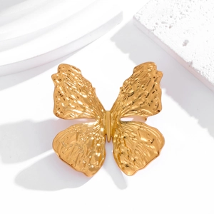 Elegant 3D gold butterfly brooch with a hammered metal texture on white platform