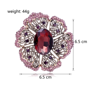 Vintage floral brooch with red center crystal and purple rhinestones in gold finish