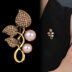 Elegant gold leaf brooch with pink diamonds and pearls, close-up and model view