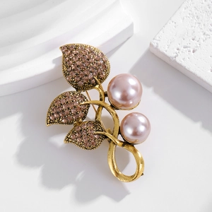 Elegant floral alloy brooch with pink faux pearls and crystal inlaid leaves on white decor