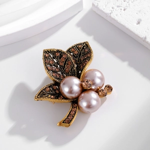 Vintage leaf brooch with gold plating, brown rhinestones, and large purple pearls