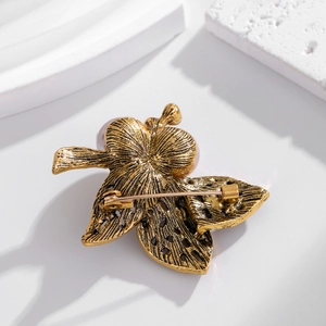 Vintage leaf brooch in alloy with rhinestones and pearl detail, back view with secure pin