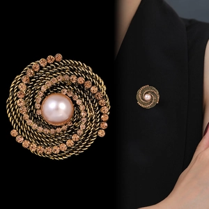 Vintage spiral gold brooch with a large central pearl and sparkling champagne rhinestones