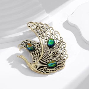 Vintage golden phoenix brooch with peacock design and colorful opal-style gemstones