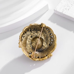 Vintage gold pearl brooch back view with ornate texture and secure pin fastening