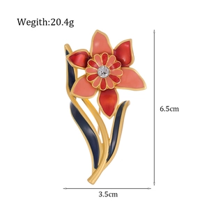 Vintage orchid flower brooch with enamel finish and crystal center on white background