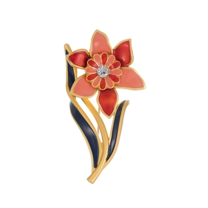 Detail of vintage orchid brooch with red enamel petals and a sparkling crystal center