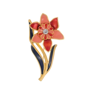 Vintage gold orchid brooch with red enamel petals and a central crystal diamond