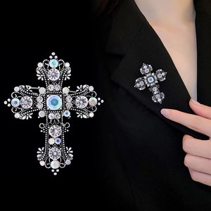Vintage Baroque cross brooch with colorful crystals and rhinestones on black background