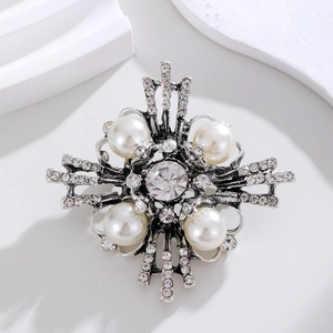 Vintage cross brooch featuring large pearls and sparkling crystals in antique silver finish