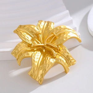 Elegant gold lily flower brooch with hammered texture in vintage French metal style