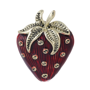 Vintage strawberry brooch with red enamel and gold-plated details on white background