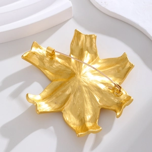 Vintage irregular golden flower brooch with matte metallic finish and secure pin back