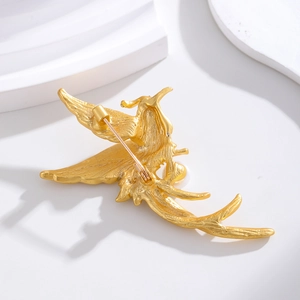 Vintage gold phoenix brooch with pearl accent, back view showing the pin fastener