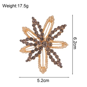 Elegant starburst brooch with smoky grey rhinestones and central gem, 6.2cm size