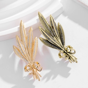 Detailed view of elegant wheat stalk brooches with crystals and bowknot motifs