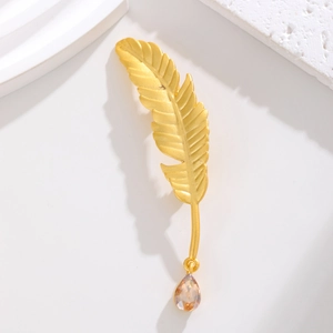 Elegant matte gold feather brooch with a dangling champagne pear-cut gemstone pendant