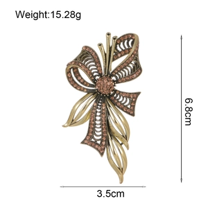 Vintage gold bow brooch with amber rhinestones, dimensions 6.8cm by 3.5cm, weight 15.28g