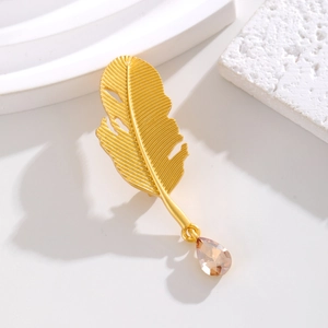 Exquisite Feder-Brosche in Gold mit bernsteinfarbenem Kristall in edlem Design