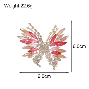 Sparkling crystal butterfly brooch with red gemstones in a 6.0cm gold-tone metal setting