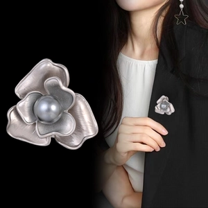 Vintage gold-plated flower stud earrings with elegant pearls on black blazer outfit