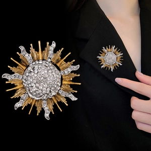 Vintage sun and moon alloy brooch with rhinestones shown as a close-up on a suit lapel