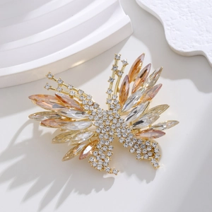 Elegant 3D butterfly brooch with champagne crystals on a gold base, professional view