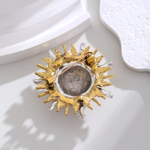 Vintage sunburst brooch with bicolour metal textures and secure back pin closure