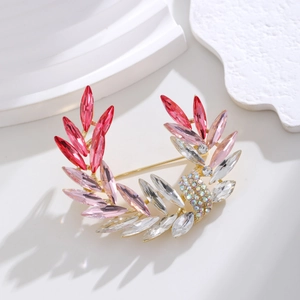 Elegant gold-tone crystal brooch with gradient pink to red rhinestones in wheat leaf shape