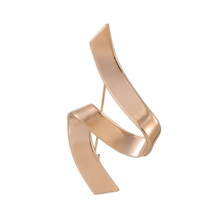 Macro shot of rose gold ribbon brooch showing smooth mirror-polished finish and metal curves
