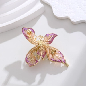 Élégante broche papillon avec ailes émaillées dégradé violet et orange et cadre doré