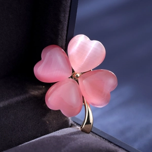 Eleganter Kleeblatt-Anstecker mit rosa Opal-Herzen in einer dunkelgrauen Schmuckschatulle