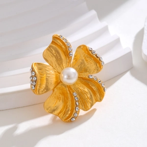 Elegant gold flower brooch with brushed metal petals, zircon edges and a large center pearl