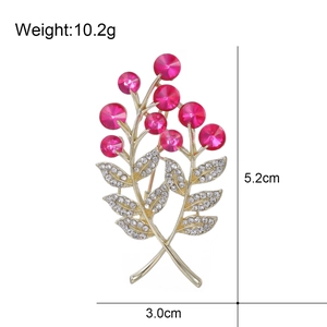 Élégante broche baie dorée avec pierres roses et cristaux, dimensions 5,2cm x 3,0cm