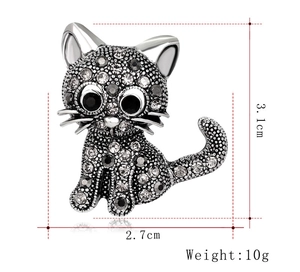 Detail view of cat brooch with dimensions 3.1cm by 2.7cm and sparkling rhinestones